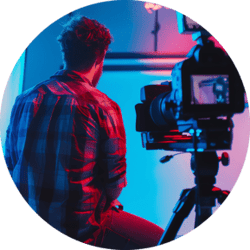 videographer-is-filming-scene-studio-with-blue-pink-lighting (1)